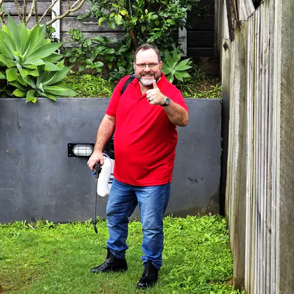 Philippe with enzyme deodorising spray in a Gold Coast backyard