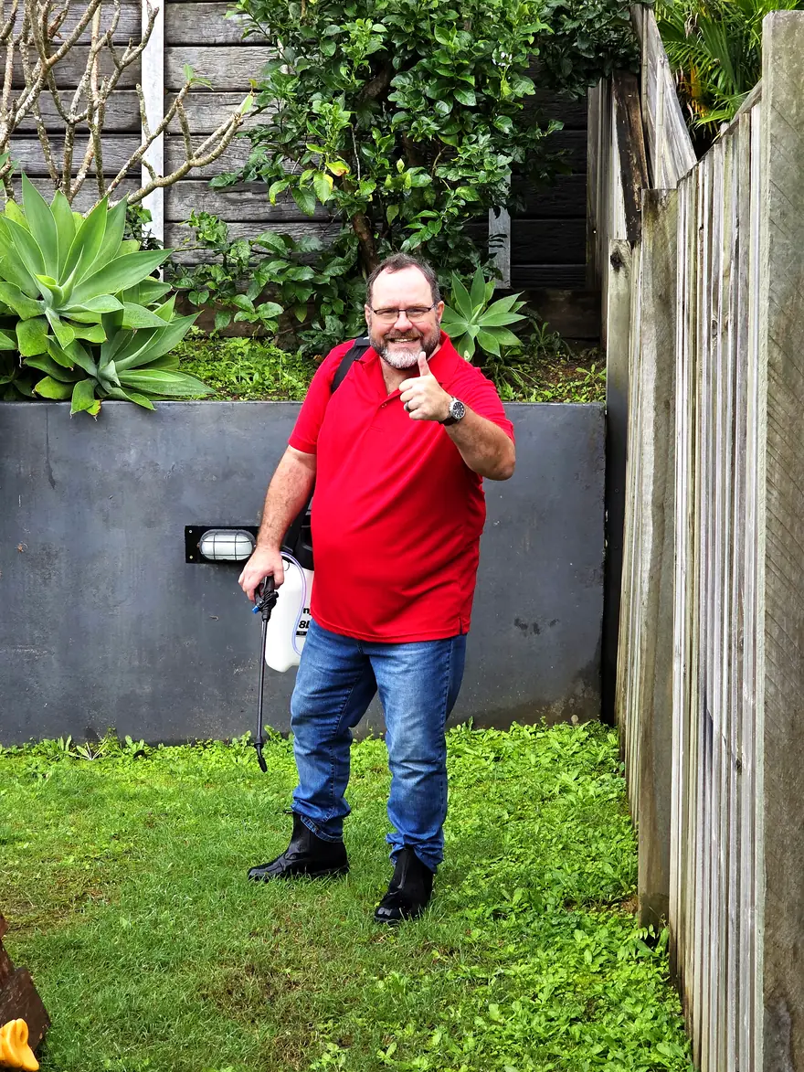 Philippe with enzyme deodorising spray in a Gold Coast backyard