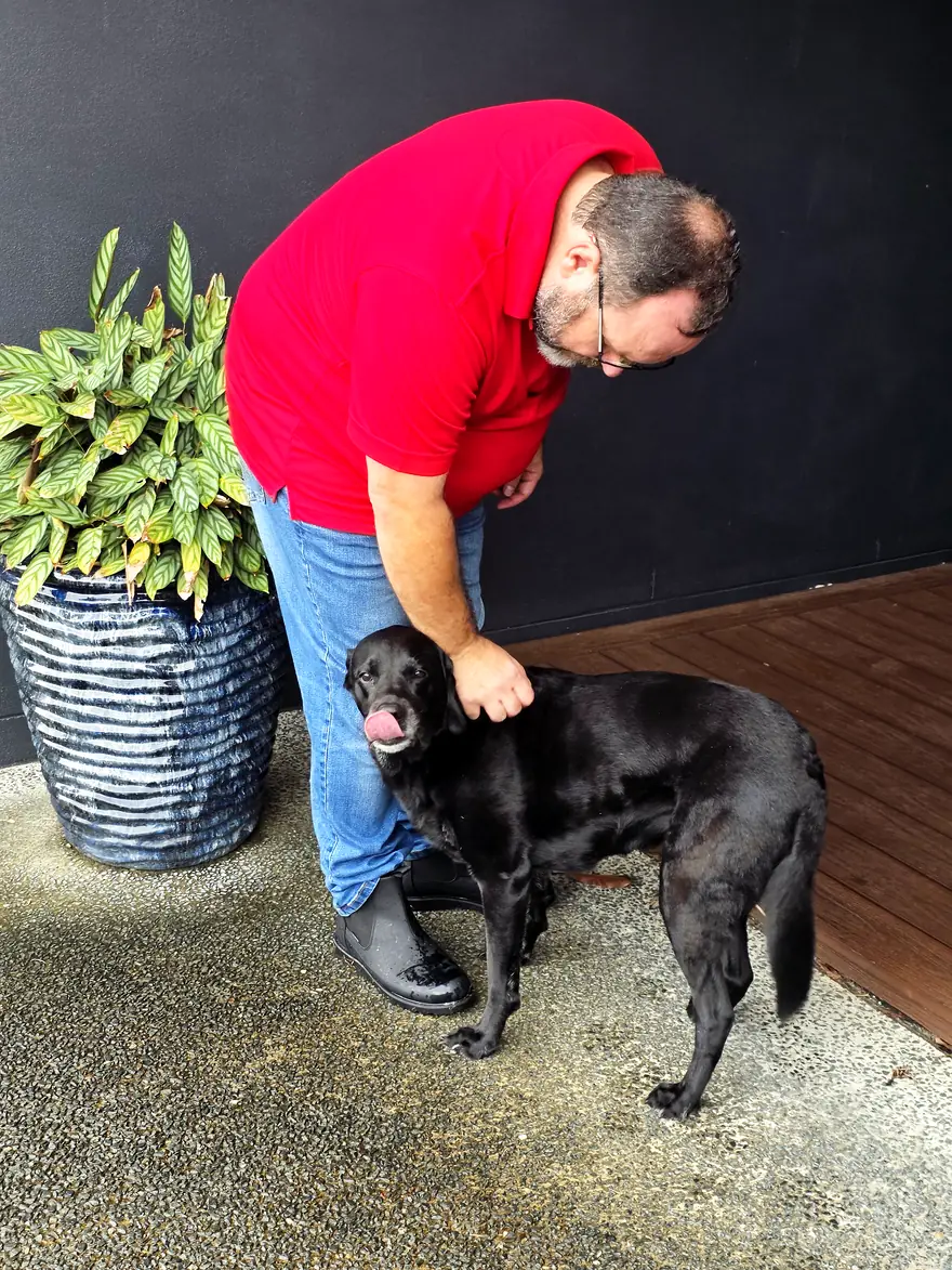 Philippe with a happy dog in a Gold Coast backyard